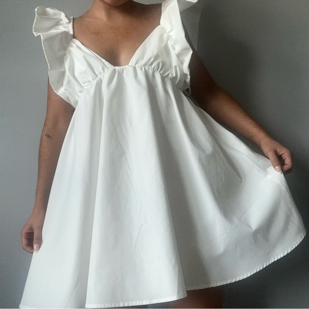 White mini dress with ruffle sleeves